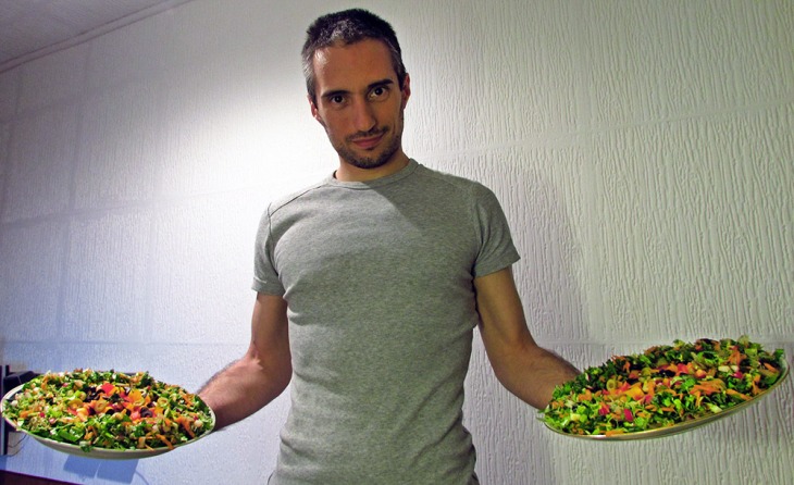 Mladen holding two raw pizzas